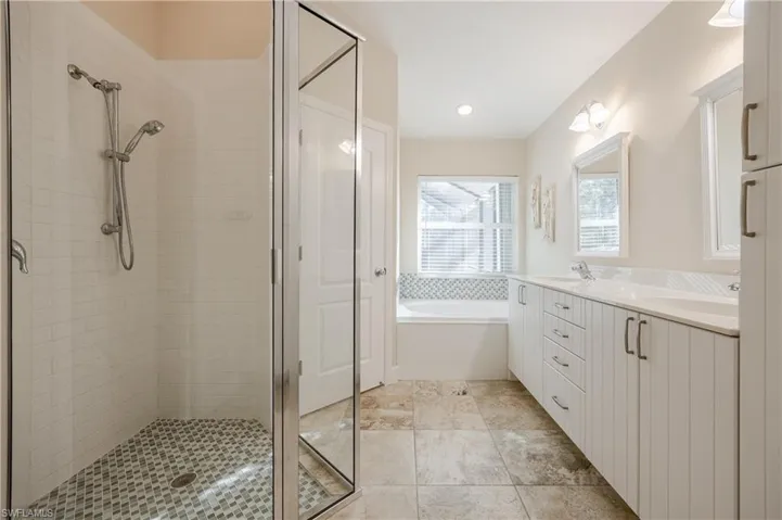 Bathroom with vanity and shower with separate bathtub