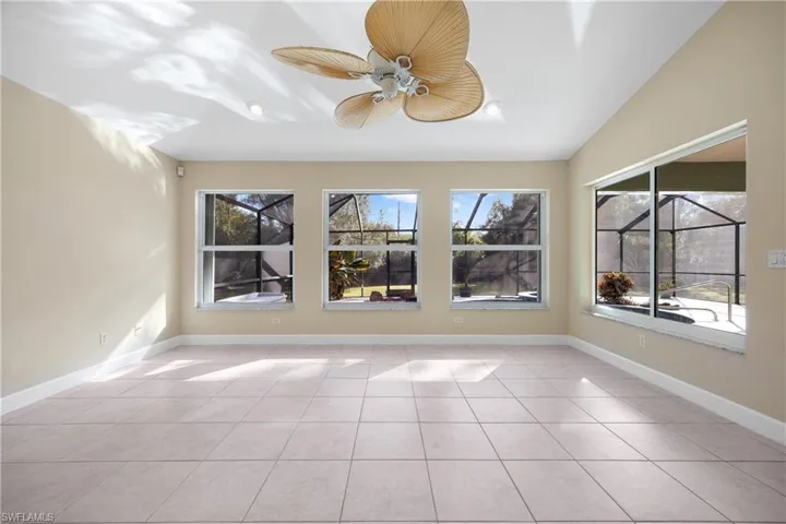 Unfurnished sunroom with lofted ceiling, a healthy amount of sunlight, and ceiling fan