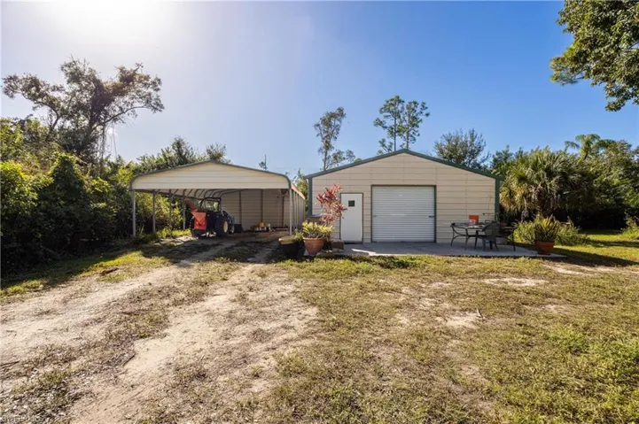 Garage featuring a carport