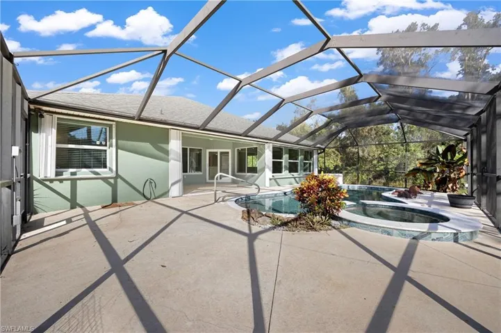 Unfurnished sunroom with lofted ceiling and a swimming pool