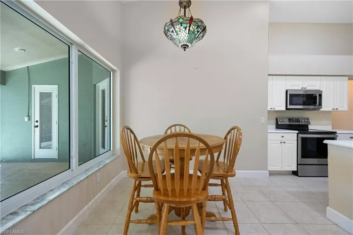 Dining area with light tile patterned floors