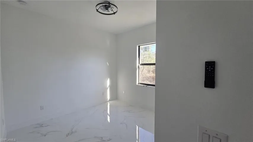 Empty room featuring light marble finish floors