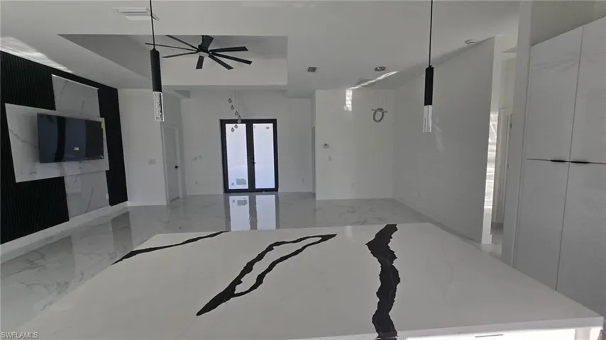 Unfurnished bedroom with light marble finish flooring and baseboards