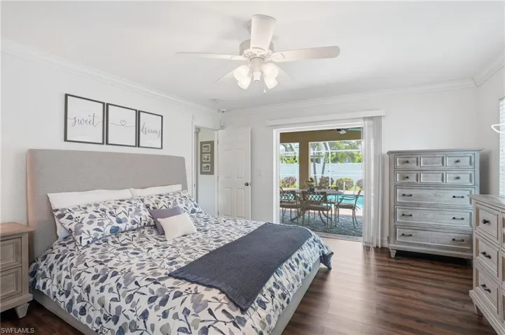 Spacious room featuring wood-finish flooring and crown molding