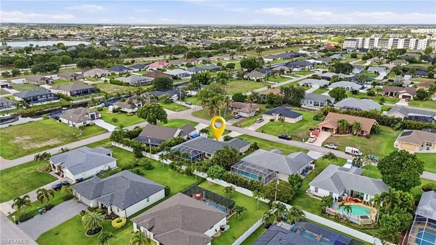 Residential neighborhood featuring single-story homes with shingle roofs and manicured lawns