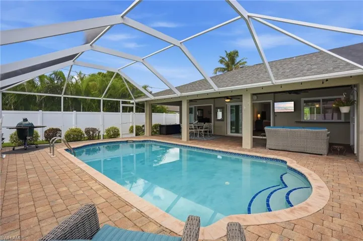 Screen-enclosed pool area with brick paver decking