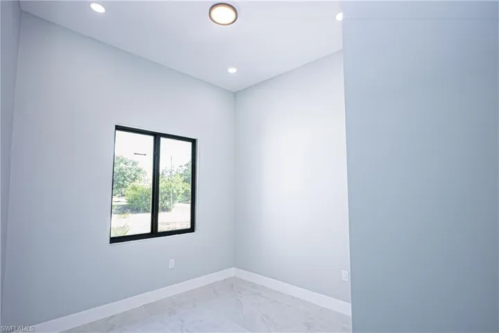 Spare room with recessed lighting, baseboards, and marble finish floor
