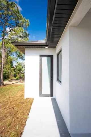 Property entrance with stucco siding