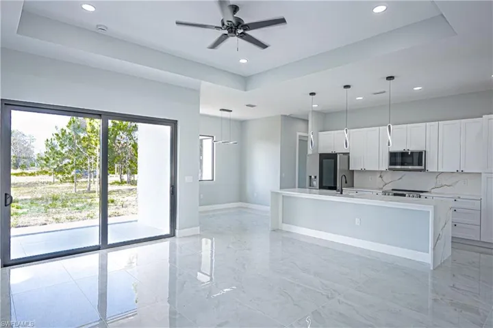 Kitchen featuring light countertops, appliances with stainless steel finishes, and recessed lighting