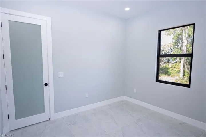 Empty room featuring recessed lighting, baseboards, and marble finish floor
