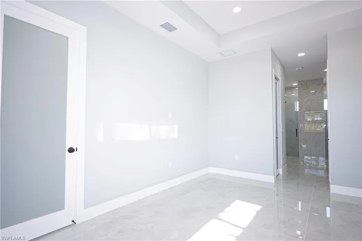 Spare room with recessed lighting, baseboards, visible vents, and marble finish floor