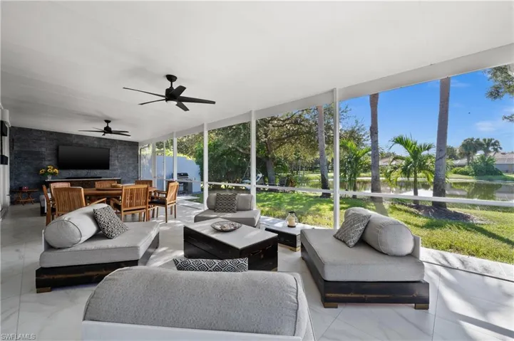 Sunroom / solarium featuring a water view and ceiling fan