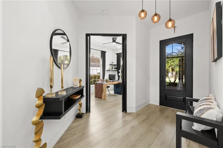 Foyer entrance featuring ceiling fan and light hardwood / wood-style flooring
