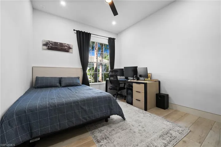 Bedroom featuring ceiling fan and hardwood / wood-style flooring