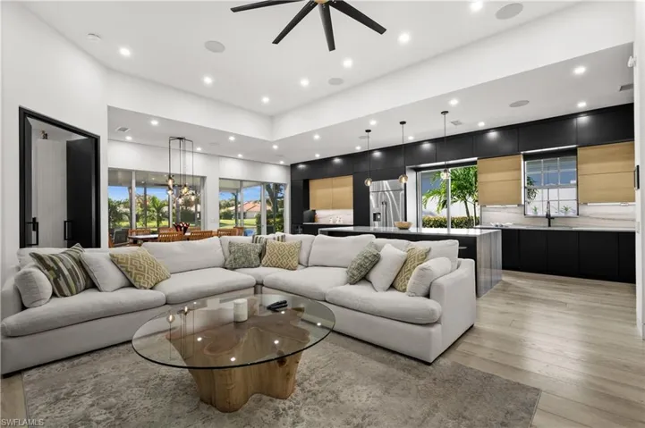 Living room with ceiling fan and light hardwood / wood-style flooring