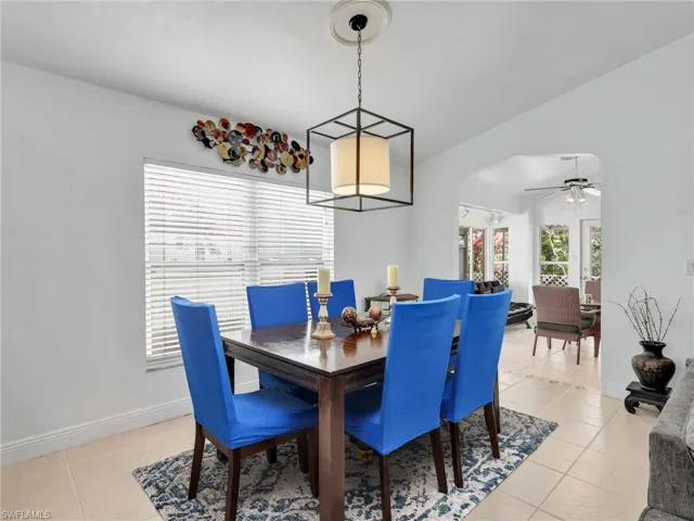 Dining area with a ceiling fan and light tile patterned floors