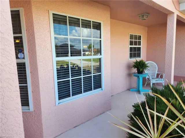 View of exterior entry featuring stucco siding