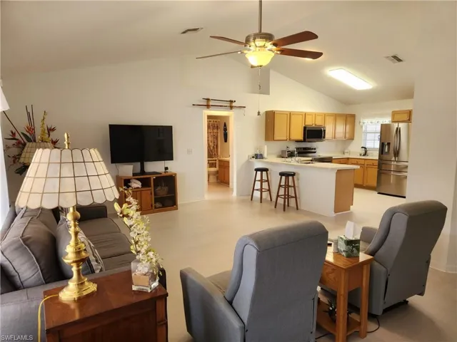 Living area with ceiling fan and Cathedral ceiling