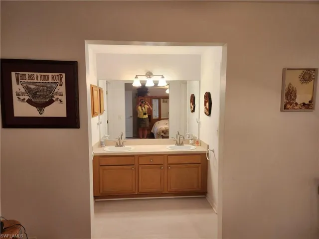 Full bath with double vanity and connected bathroom