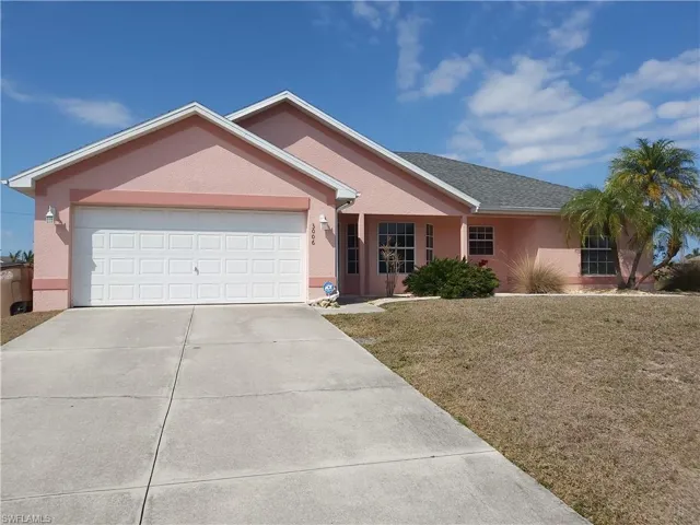 Ranch-style home with a 2 car garage driveway, a front yard, and roof with shingles