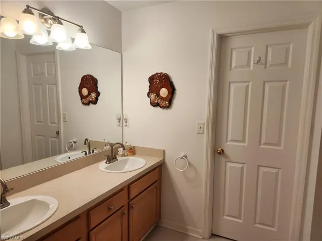 Full bath featuring double vanity