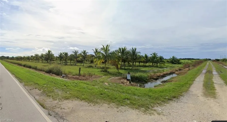 View of dirt / gravel road featuring a view of rural / pastoral area