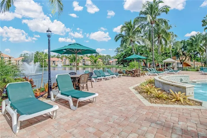 View of patio / terrace featuring a water view and a community pool