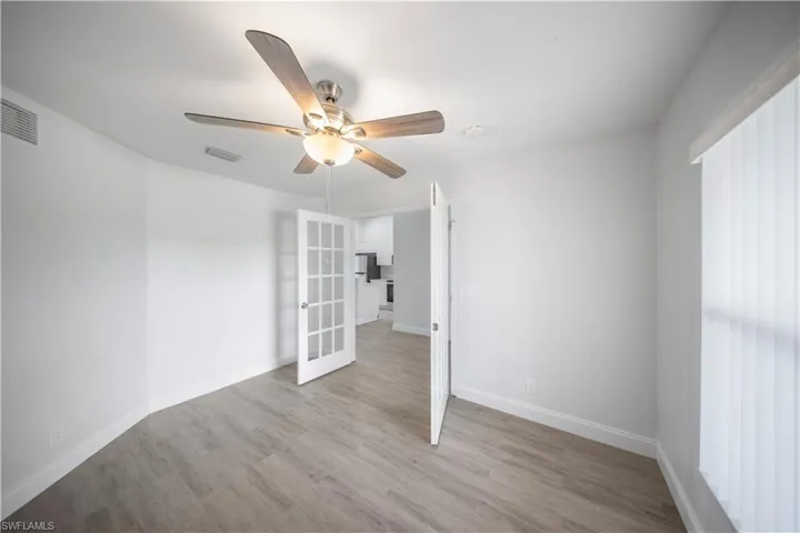 Unfurnished room with light wood-style flooring and ceiling fan