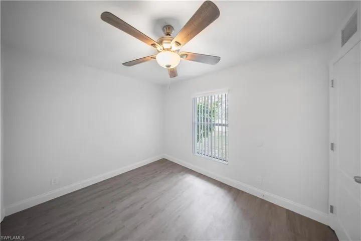 Spare room featuring wood finished floors and ceiling fan