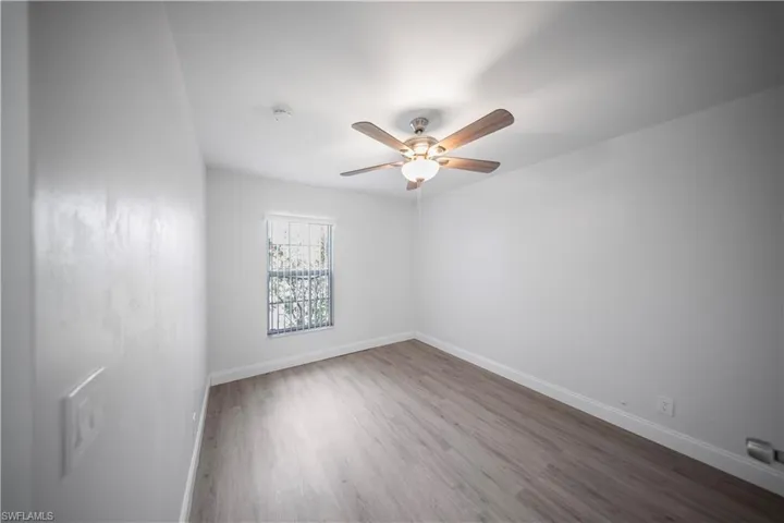 Unfurnished room with wood finished floors and ceiling fan