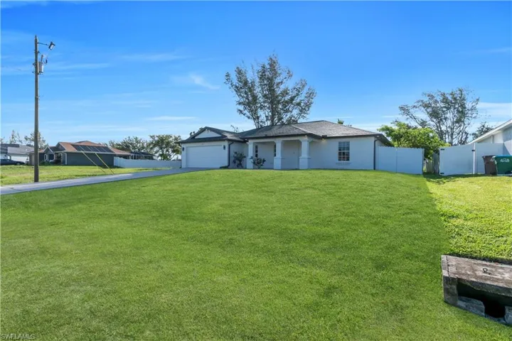 Ranch-style home with a garage and driveway