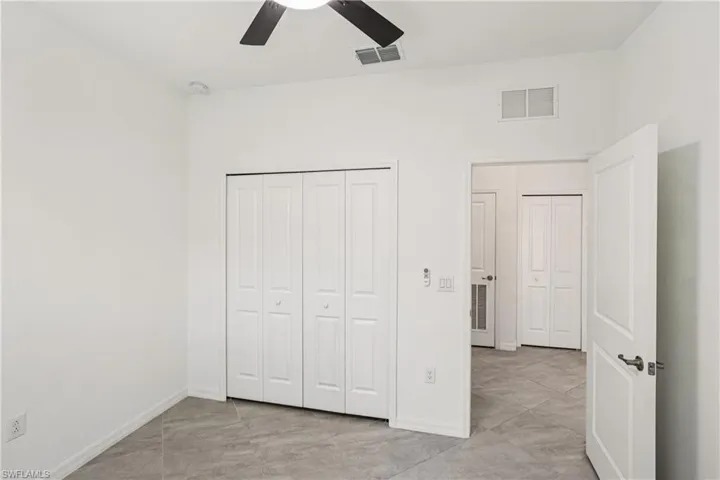 Unfurnished bedroom with a closet and a ceiling fan
