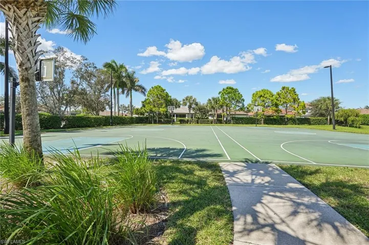 View of basketball court featuring community basketball court and a yard