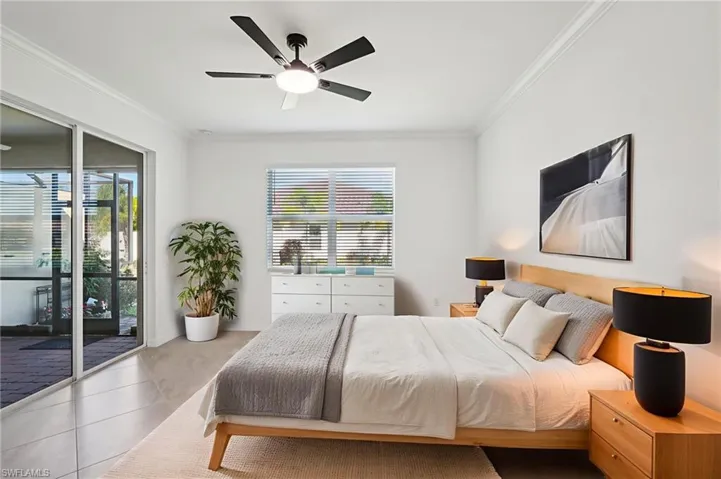 Bedroom featuring access to outside, ornamental molding, ceiling fan, and tile patterned flooring