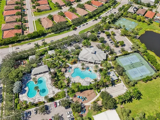 Aerial view of property and surrounding area featuring a pool