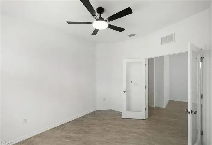 Unfurnished bedroom featuring ceiling fan and baseboards