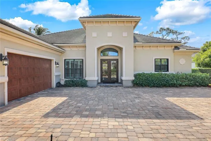 Welcome family & guests through this  classic gable roofline and welcoming arched, covered entryway.