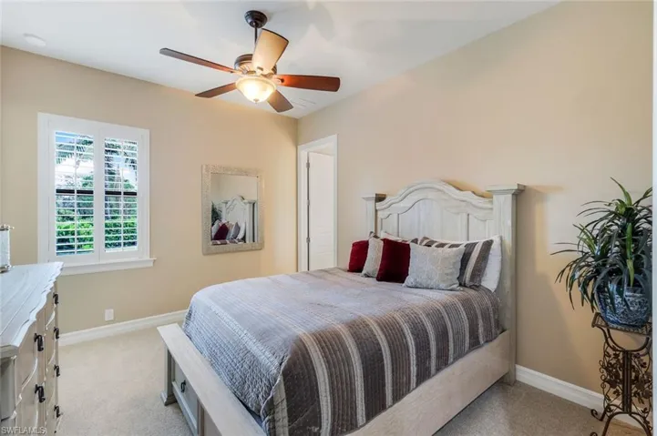 Carpeted bedroom with ceiling fan