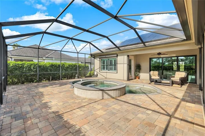 View of patio with ceiling fan, a lanai, an outdoor hangout area, and an in ground hot tub