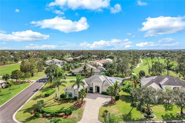 Located on a desirable corner lot with an oversized yard, this home is surrounded by lush landscaping and framed by tropical palm trees. Its well-maintained lawn and light-colored exterior create a welcoming and spacious outdoor retreat.