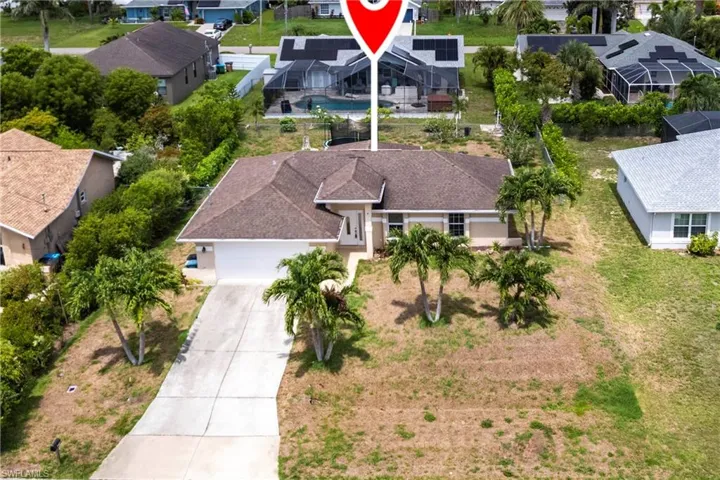 Aerial perspective of suburban area with a pool