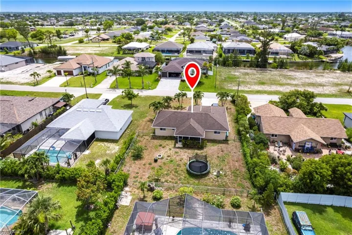 Aerial perspective of suburban area featuring a nearby body of water