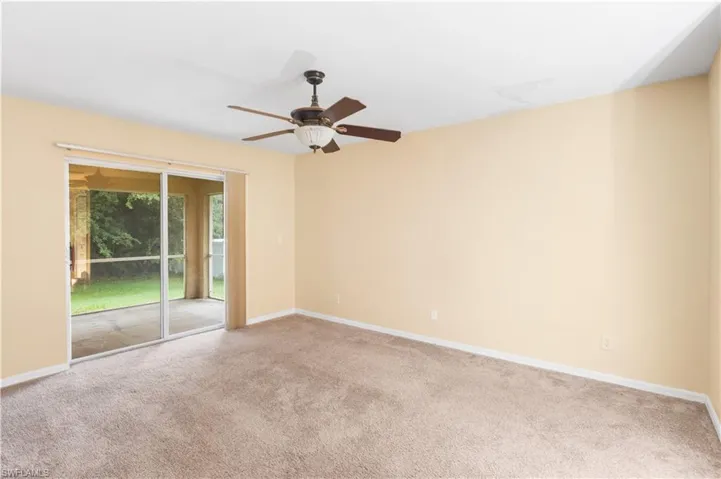 Spare room with carpet floors and a ceiling fan