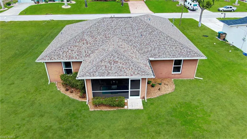 Enjoy relaxing in the large screened Lanai! Color enhanced lawn.
