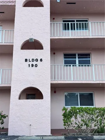 Pink stucco exterior featuring multiple balconies with white railings