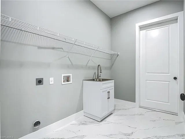 Laundry area featuring electric dryer hookup, light marble finish flooring, and hookup for a washing machine
