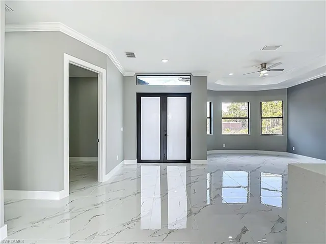 Foyer with crown molding, french doors, ceiling fan, and recessed lighting