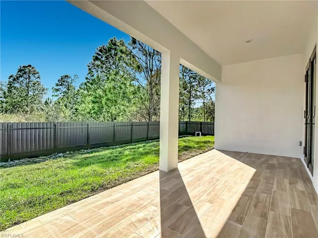 Fenced backyard with a patio