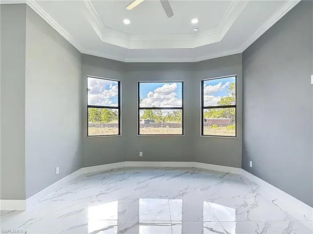 Unfurnished room with light marble finish flooring, healthy amount of natural light, a ceiling fan, and recessed lighting