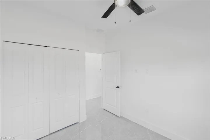 Unfurnished bedroom with a closet and a ceiling fan